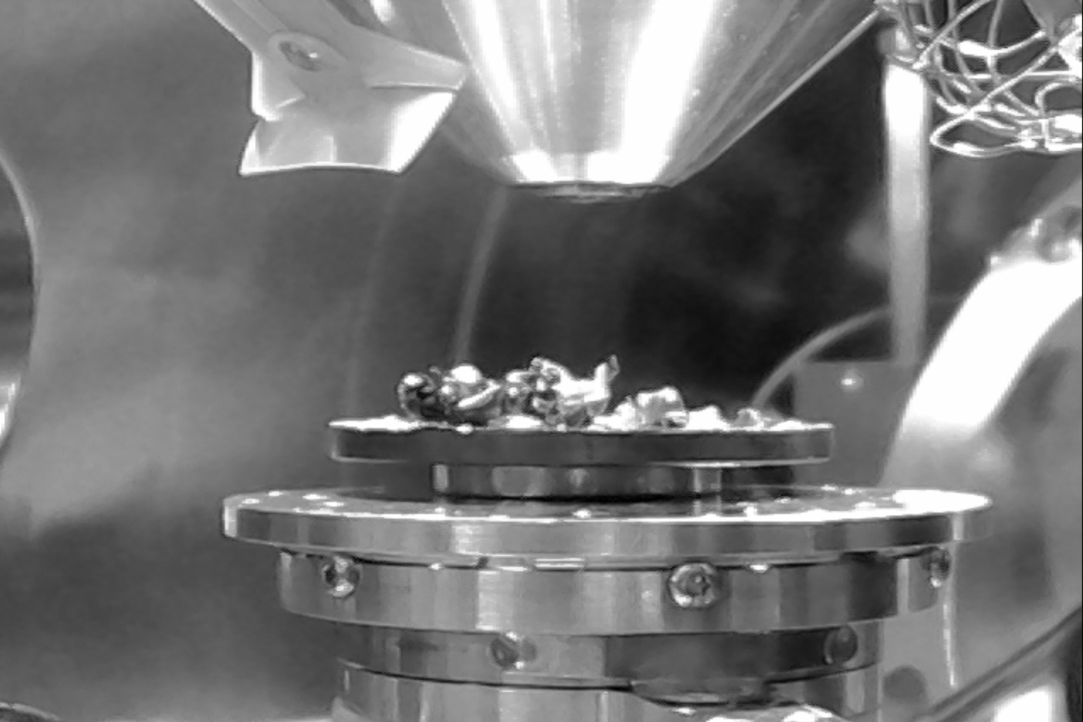 An image of the sample stage mounter inside the microscope. The electron beam comes out the pole piece (cone-shaped object, top center)